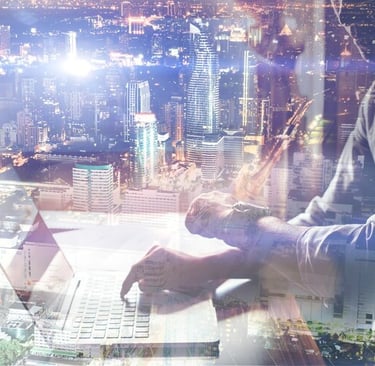 a man sitting at a desk with a laptop computer
