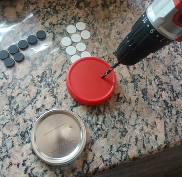 Close-up of drilling a hole into a jar lid for a DIY mycology lid.