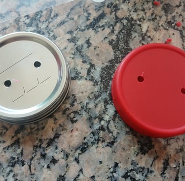 Jar lids with holes drilled, ready for adding filter patches and injection ports.