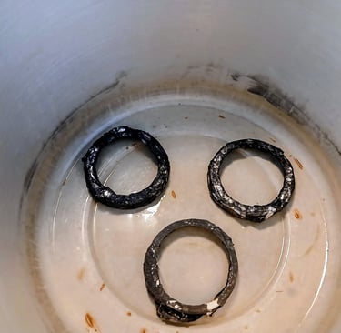 metal jar lids sitting in a pressure cooker to lift the rack off the bottom