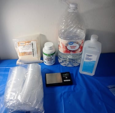 Supplies for pouring agar into ketchup cups — pressure cooker, agar powder, foil, and condiment cups