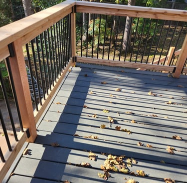 trex decking with cedar handrail and black balusters