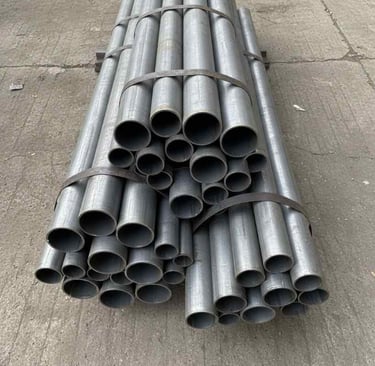 Top view of assorted round steel pipes arranged for catalog display.