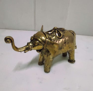"Handcrafted shiny brass baby elephant with tribal engravings, left side view-Going abroad"