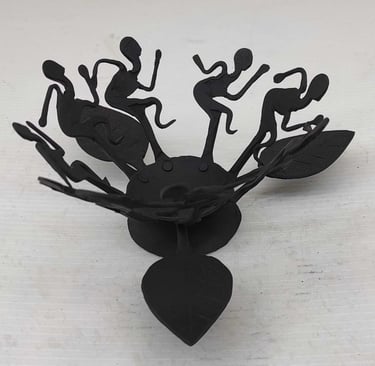 "Handcrafted tribal iron oil lamp with dancing figures–front view–for international delivery"