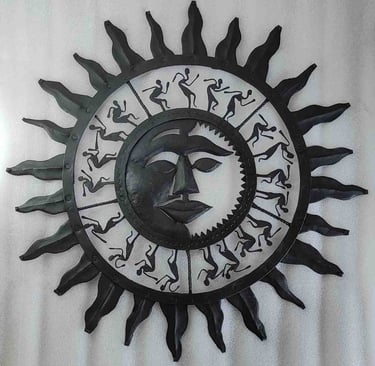 "Handcrafted iron wall art featuring sun face and dancing tribal figures–Bastar decor-for global markets"