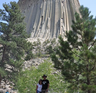 couple standing in front of devils tower, wyoming