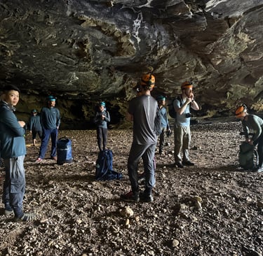 kitting up in the entrance to hang en cave, Ke Bang national park, Vietnam
