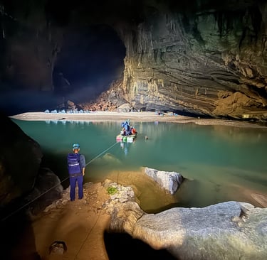 crossing Hang En cave lake in a raft, ke bang national park Vietnam