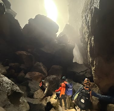Tracey Billington climbing through a boulder field in Hang Son Doong Cave to get to doline 1