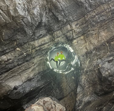 Nick and Tracey Billington climbing through the James Bond hole in Hang Son Doong Cave 