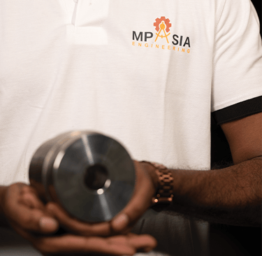 MP Asia Engineering Staff holding a CNC Precision Tool