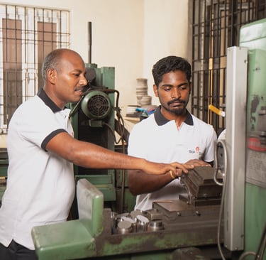 MP Asia Engineering staff working on CNC machine