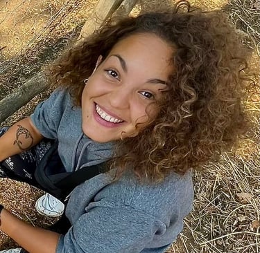 a woman smiling sitting on the ground