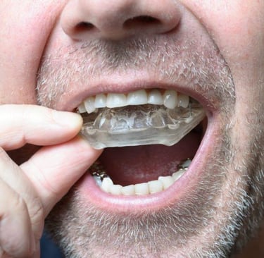 a person inserting night guard in mouth