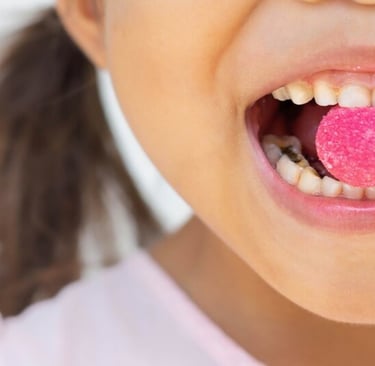 a child  with dental caries having candy in mouth