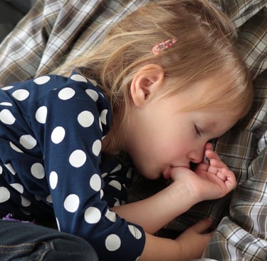 a kid sucking thumb in sleep