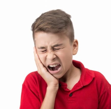 a boy holding hands in cheek with severe toothache
