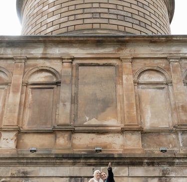 a bride and groom standing on a balcony