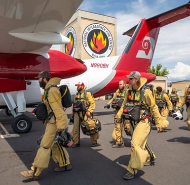 NIFC Smokejumpers in full gear by airplane Photo by Neal Herbert