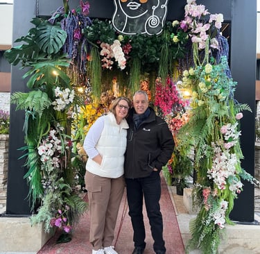 David Helberg with his wife (Amy) standing, surrounded by flowers