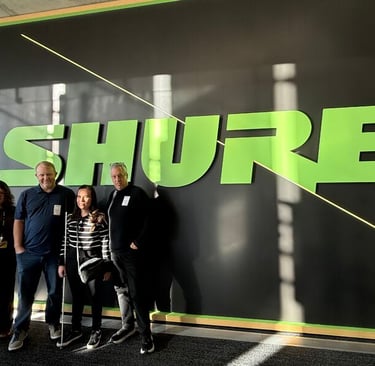 Michelle  Felix standing with SHURE Inc. team