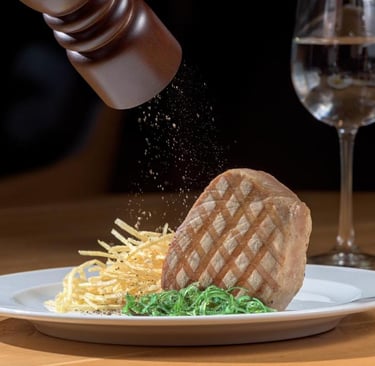 Fresh black pepper ground over a grilled steak fillet served with crispy shoestring fries.