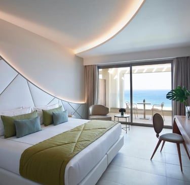 Luxury modern hotel suite with ocean view balcony, king bed, and stylish interior design.