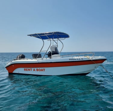 Small white motorboat with orange stripe and blue canopy for rent on turquoise ocean water.