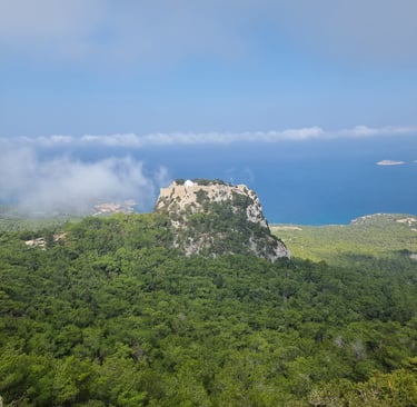 Medieval Monolithos castle on a rocky peak overlooking the Aegean Sea in Rhodes, Greece.
