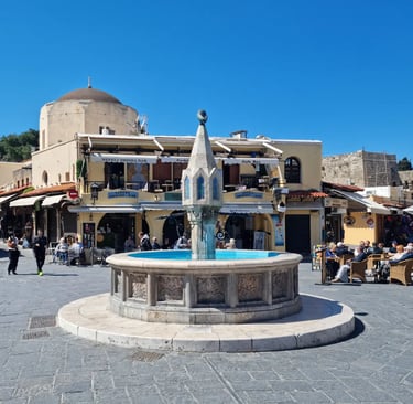 rhodes old town with a fountain in the middle of a square