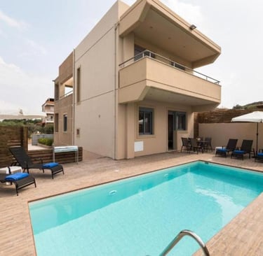 Luxury modern villa with private outdoor swimming pool and sun loungers for a relaxing vacation.