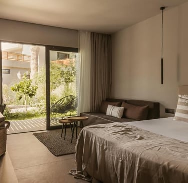 Modern luxury hotel room with king bed, private garden terrace, and minimalist interior design.