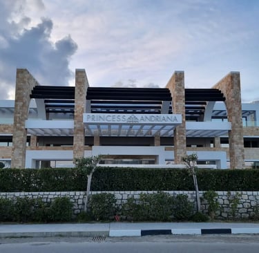 front entrance of princess andriana hotel with hotel sign
