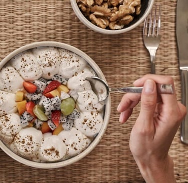 Elegant hotel room with a modern bed, private balcony, and stunning ocean views, perfect for a relaxing getaway.