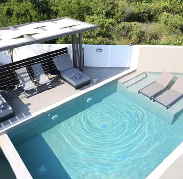 Luxury modern villa patio with private swimming pool, sun loungers, and pergola.