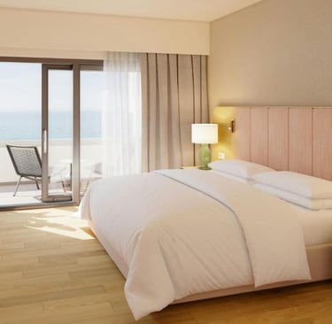 Modern luxury hotel room with a plush double bed, private balcony, and scenic ocean views.