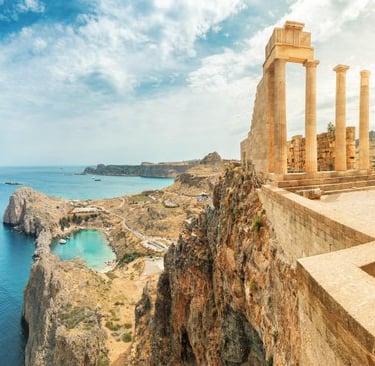 Ancient ruins of the Acropolis of Lindos overlooking the blue Aegean Sea and St. Paul's Bay in Rhodes, Greece.
