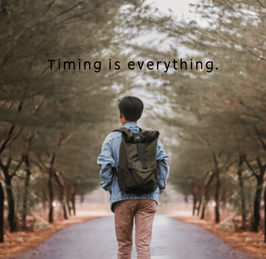 a man walking down a road with a backpack on his back