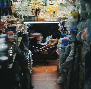 Market vendor relaxing in Saigon