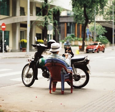 Motorbike driver resting on the street in Saigon