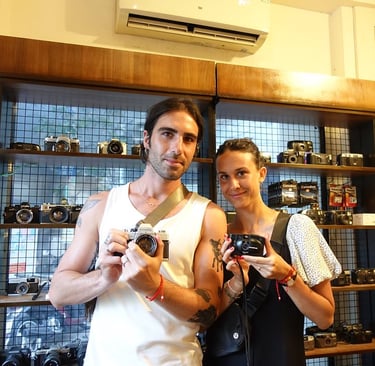 Photographers in Saigon holding analog cameras