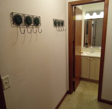hallway leading to 1/2 bath