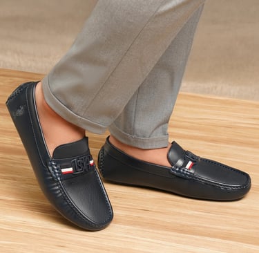 a person wearing a pair of shoes with a red, white and blue stripe
