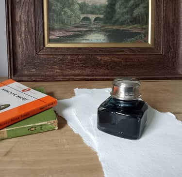 J Herbin Paris ink bottle with silver lid and pen rest