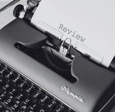 Writing machine with a paper written "review" | review services