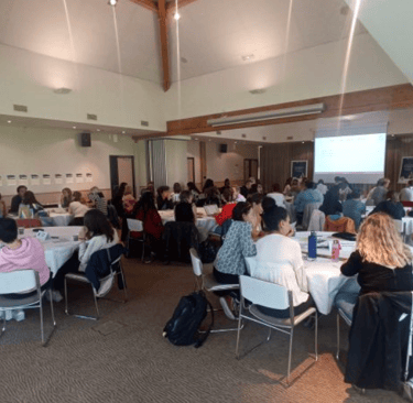 a group of people sitting at tables in a room