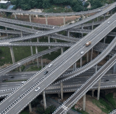 a large group of cars driving through a large intersection