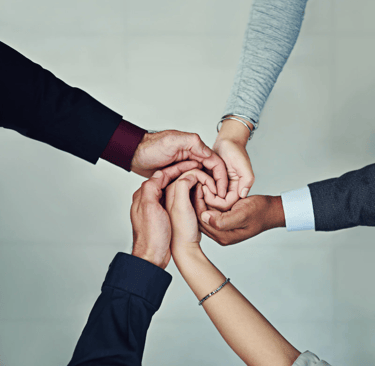a group of people holding hands together