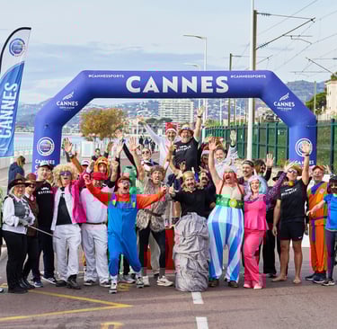 a group of people standing in front of a sign that says cannes for movember